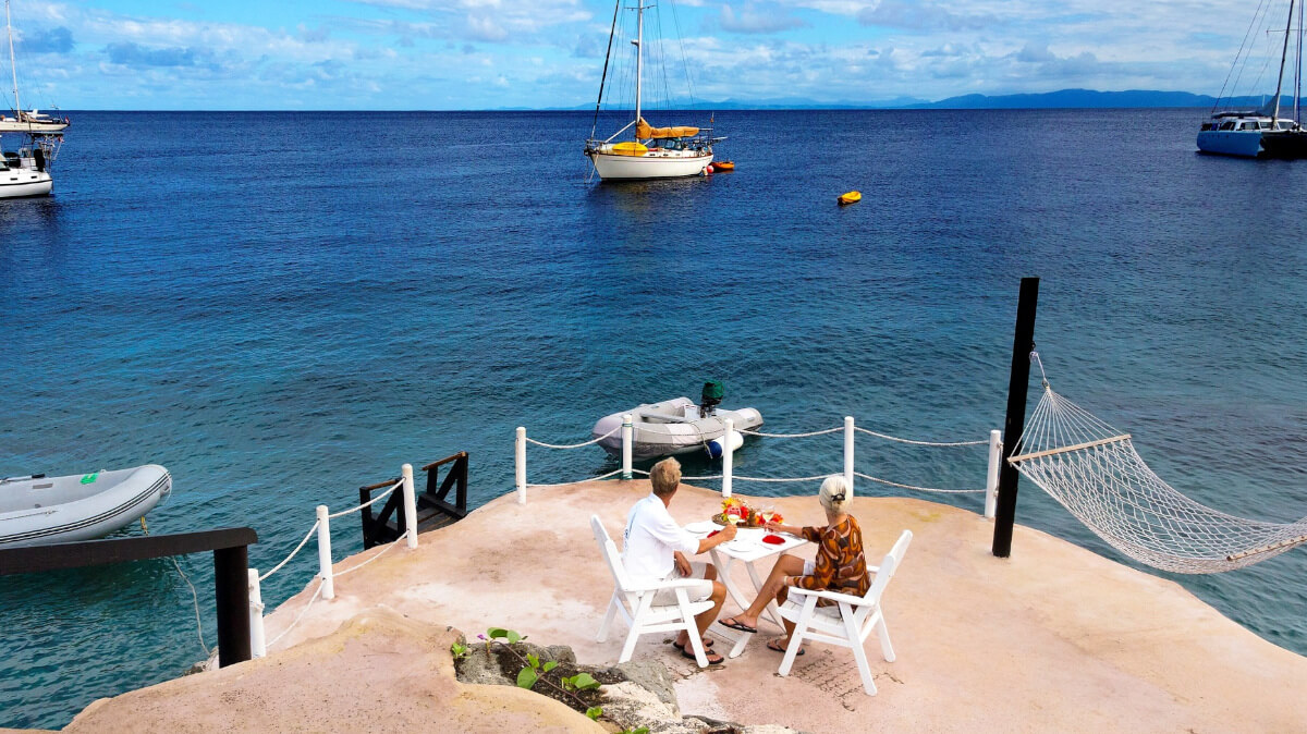 Honeymoon couple sitting on pier
